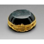 A small yellow metal and carved bloodstone snuff box, of quatrefoil form with hinged lid and shell