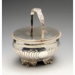 A late George III silver double sided tea caddy, the oval body partly fluted, standing on four