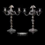 An impressive pair of Regency silver four-light candelabra, each on a shaped circular base rising to