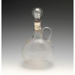 A Victorian silver mounted glass claret jug, the clear glass body of circular flask form and