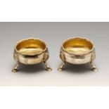 A pair of George III silver open salts, each of cauldron form with gadrooned rim, vacant cartouche