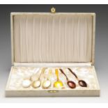 A set of six silver-gilt teaspoons, each with guilloche enamelled decoration of varying colour, in