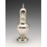 A large Edwardian silver caster, the panelled baluster body decorated with repeated foliate motifs