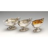 A set of three George III silver pedestal open salts, each of twin-handled octagonal sided form,