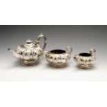 A George IV silver three piece tea service comprising teapot, twin-handled sugar bowl and cream jug,