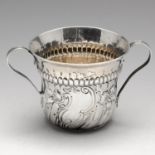 A George III silver porringer, of circular form with a wrythen lower body, central asymmetrical