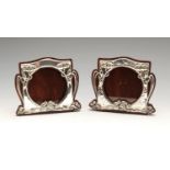 A pair of similarly matched Art Nouveau silver mounted photograph frames, the circular aperture with