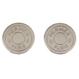 HERMÈS - a pair of ear clips. Of circular outline with 'Hermès Paris' stamped within two consecutive