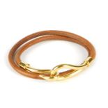 HERMÈS - a Jumbo Choker necklace. Designed as a tan leather cord, with gold-tone metal hook terminal