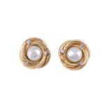 CHANEL - a pair of clip-on earrings. The imitation pearls to the centre, with rope-twist swirl-