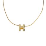 HERMÈS - a Pop H necklace. Featuring maker's ivory enamelled 'H' emblem on a gold-tone snake
