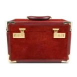 CARTIER - a Must De Cartier travel vanity case. Designed as an emblazoned suede and leather burgundy