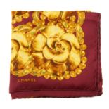 CHANEL - a Camellia scarf. A burgundy scarf featuring two wide golden camellia flower borders.