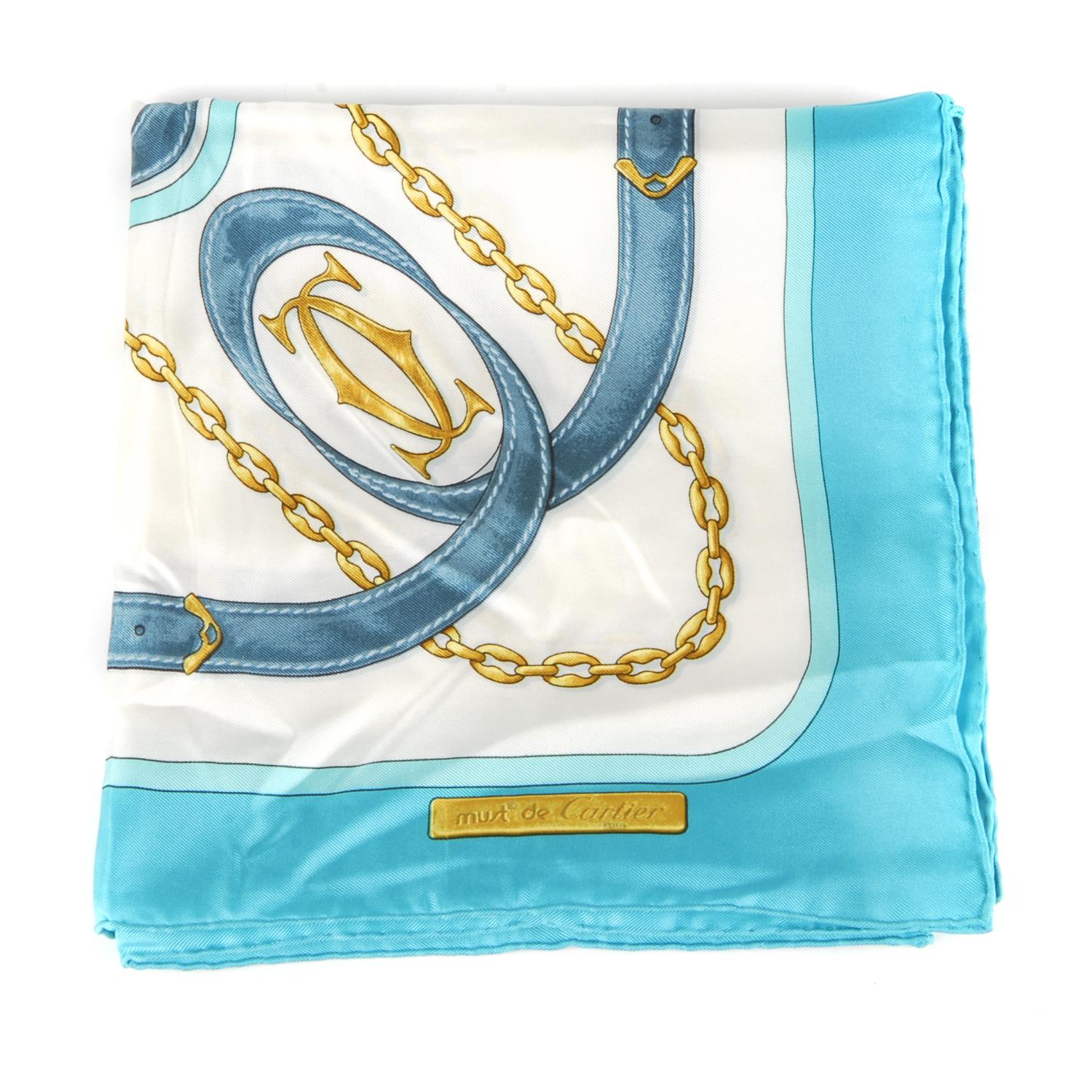CARTIER - a 1980s Must De Cartier silk scarf. Featuring a stylised equestrian print with belt straps