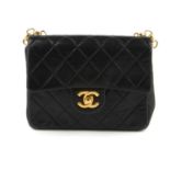 CHANEL - a black vintage Mini Classic Flap handbag. Designed with a black quilted lambskin leather