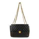 CHANEL - a 90s Jumbo Classic Flap handbag. Featuring maker's iconic black quilted lambskin leather