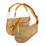 CHRISTIAN DIOR - two Rasta saddle handbags. Both designed with maker's beige logo canvas