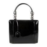 CHRISTIAN DIOR - a patent leather Malice handbag. Designed with a black patent leather exterior,