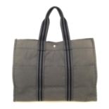 HERMÈS - a Fourre Tout canvas GM handbag. Crafted from grey cotton canvas, featuring double black