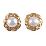 CHANEL - a pair of clip-on earrings. The central imitation pearls, to the textured, wave-like