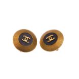 CHANEL - a pair of round logo ear clips. Designed with a central back disc with raised gold-tone
