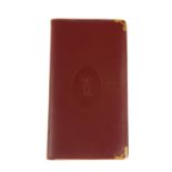 CARTIER - a Must De Cartier Bordeaux leather agenda cover with inserts. Featuring a smooth