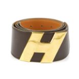HERMÈS - a 1970s belt. The wide brown leather belt, featuring maker's large gold-tone 'H' buckle
