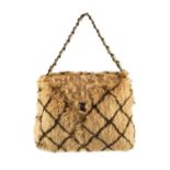 CHANEL - a fur handbag. Designed with a light brown coney fur exterior with black stencilled diamond