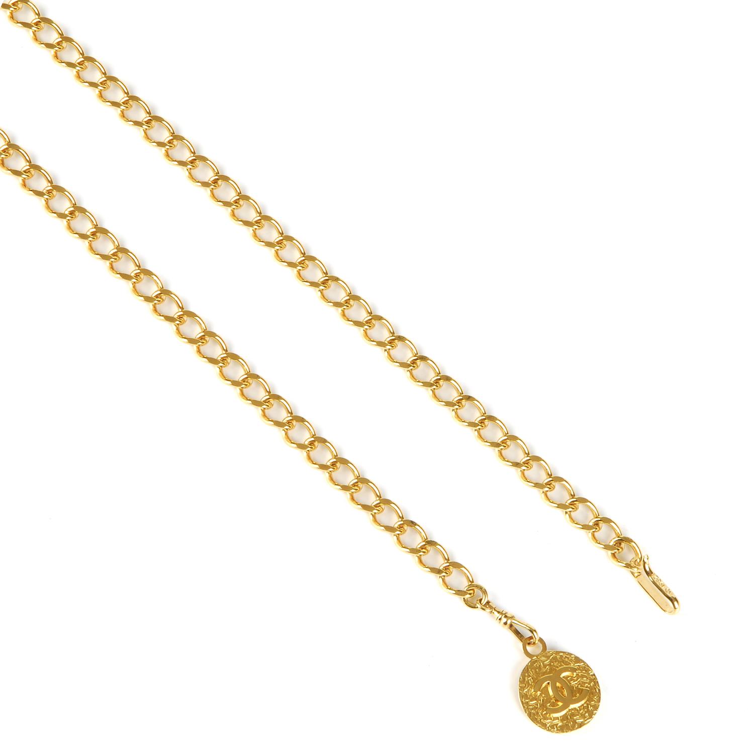 CHANEL - a chain belt. Featuring a gold-tone chain with a large logo CC medallion hanging at one end