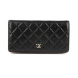 CHANEL - a Bifold wallet. Featuring a diamond quilted black leather exterior, with a rear patch