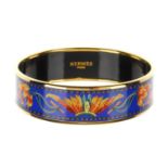 HERMÈS - an enamel printed 'Brazil' bangle. Inspired by Brazil, featuring fiery tonal orange