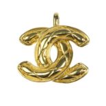CHANEL - a pendant. Designed as a gold-tone signature interlocking CC logo with a quilted pattern.