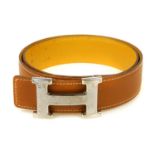 HERMÈS - a reversible logo buckle belt. Designed with grained epsom tan leather to one side and