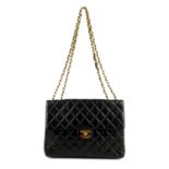 CHANEL - a Jumbo Classic Flap handbag. Featuring maker's iconic black quilted lambskin leather