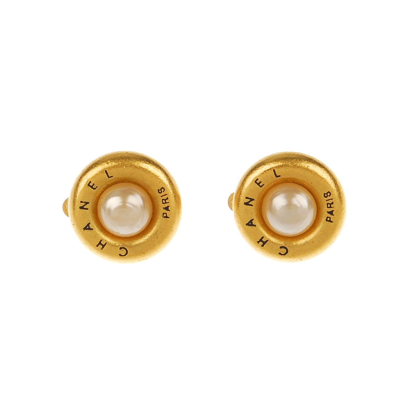 CHANEL - a pair button ear clips. Featuring an imitation pearl to the centre and a matte gold-tone