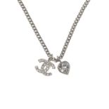 CHANEL - a logo heart pendant. Designed as an interlocking CC logo with colourless rhinestone