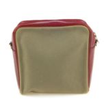 HERMÈS - a small handbag. Crafted from khaki canvas with burgundy leather trim, featuring a long