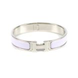 HERMÈS - a bangle. The hinged lilac enamel bangle with silver-tone hardware clasp concealed behind