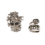 ALEXANDER MCQUEEN - two Skull rings. Both featuring silver-tone skull designs, with stone