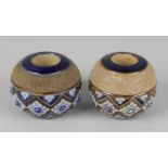 A near pair of Doulton Lambeth match pots, each of spherical form, decorated with relief foliate