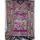 A collection of Eastern textiles, comprising a Tibetan throne rug, perhaps a High Lama's seat,