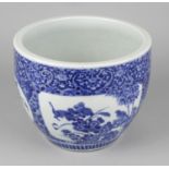 A 20th century Chinese blue and white jardiniere, the white glazed ground decorated with four shaped