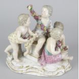 A late 19th century Meissen figure group, modelled as four putti composing a floral garland, upon
