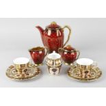 A Carlton ware 'Rouge Royale' coffee set, with white spotted decoration and gilt finished handles