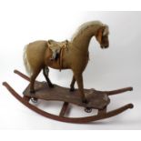 An interesting dual-function toy horse with provenance. The hessian-covered body with grey mane