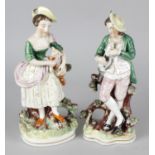 A 19th century Staffordshire figure modelled as a young male, holding a dog in his arms, together