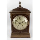 A 19th century mahogany and brass inlaid mantel clock, the case with a stepped apexed top above a