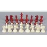 A 19th century carved and red stained ivory 'Staunton' pattern chess set, contained within a