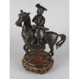 A 19th century Chinese bronze censor and cover, modelled as a horse and rider, upon a later carved