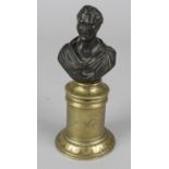 A 19th century spill holder, the cylindrical box with hinged cover, fitted with a bronze bust of the